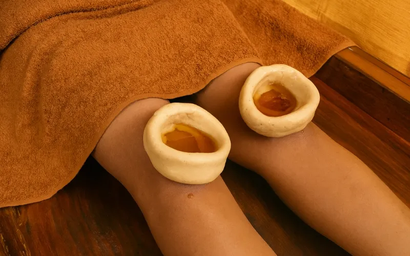 Janu Basti Ayurvedic oil therapy being administered to a patient's knee at Ayusanjivani Ayurveda clinic