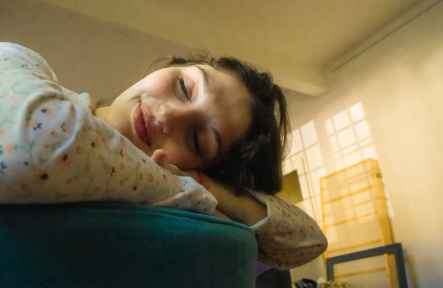 Person resting at home during the recovery period after Ayurvedic Panchakarma treatment